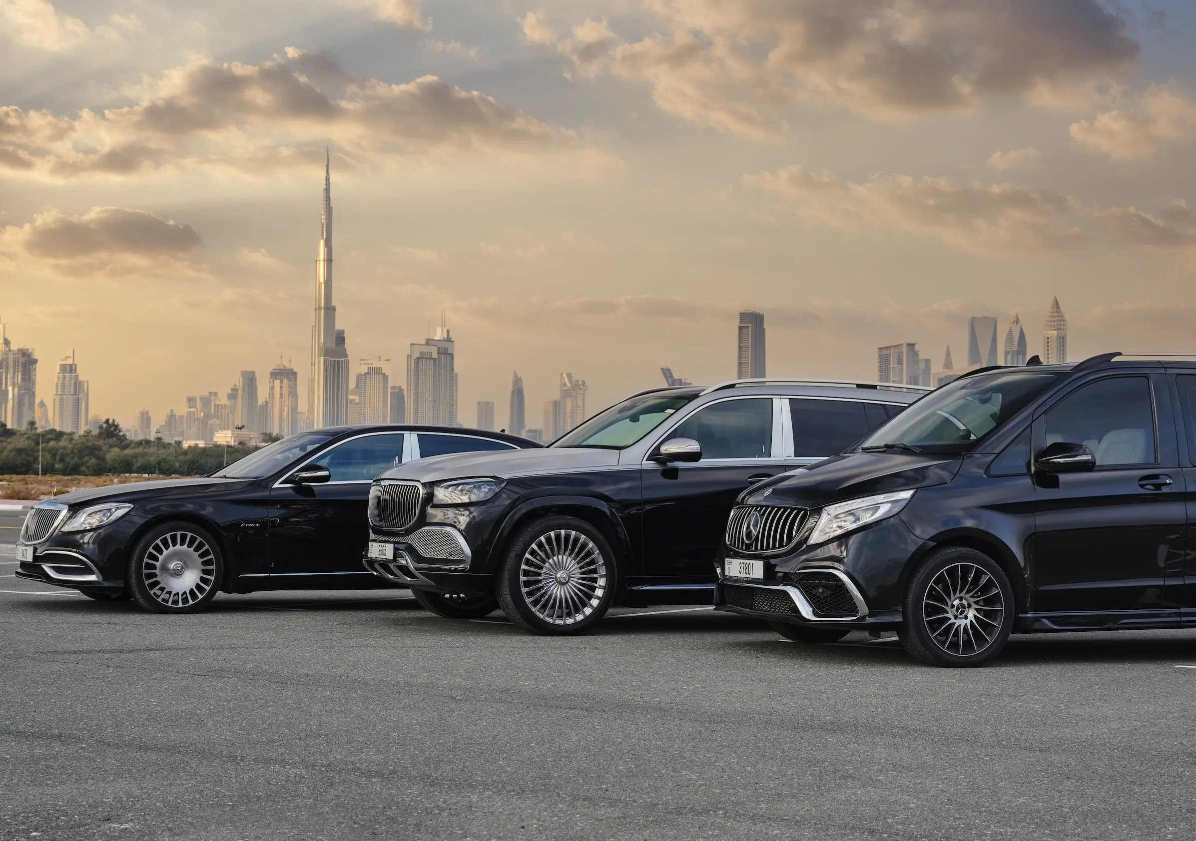 Luxury chauffeur service fleet of black Mercedes-Benz vehicles with Dubai skyline